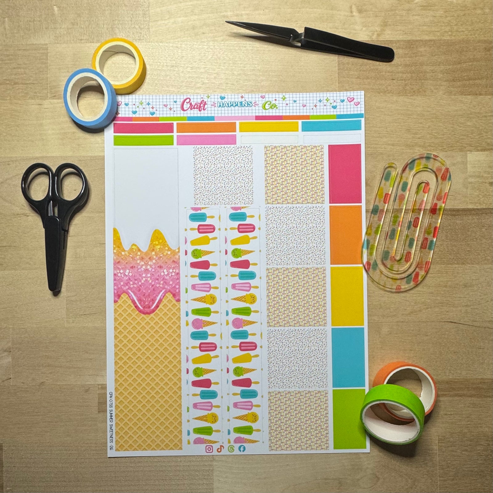 Open planner with washi tape, scissors and sticker sheets on cream linen